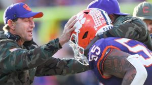 Clemson, South Carolina, USA; Clemson Tigers head coach Dabo Swinney and defensive tackles coordinator Nick Eason hug defensive tackle Payton Page (55)